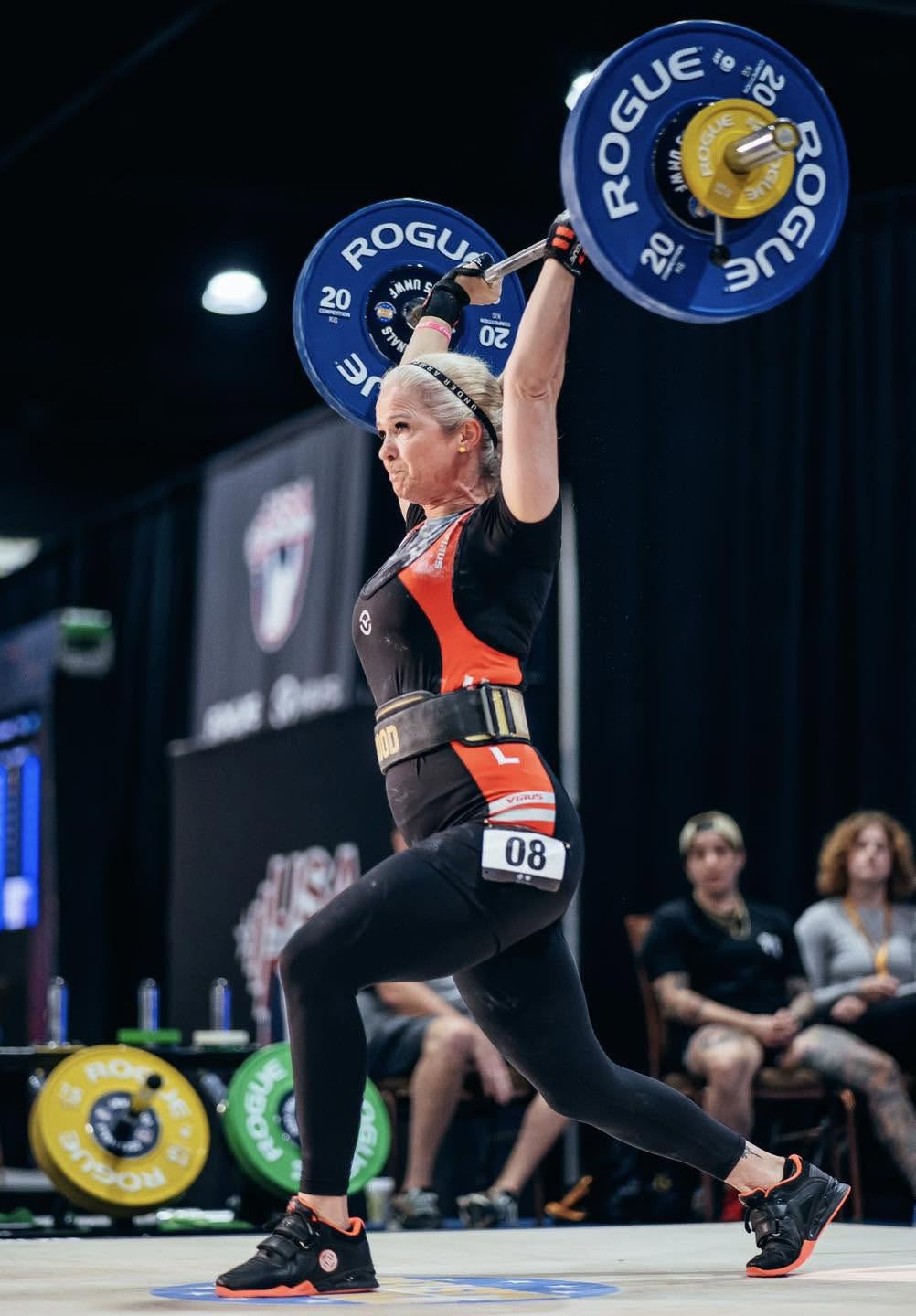 Athlete completing a split jerk in competition